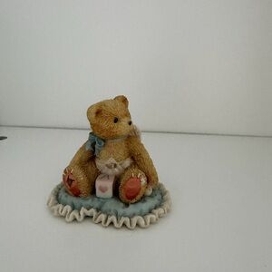 Adorable Bear Figurine on Blue Cushion